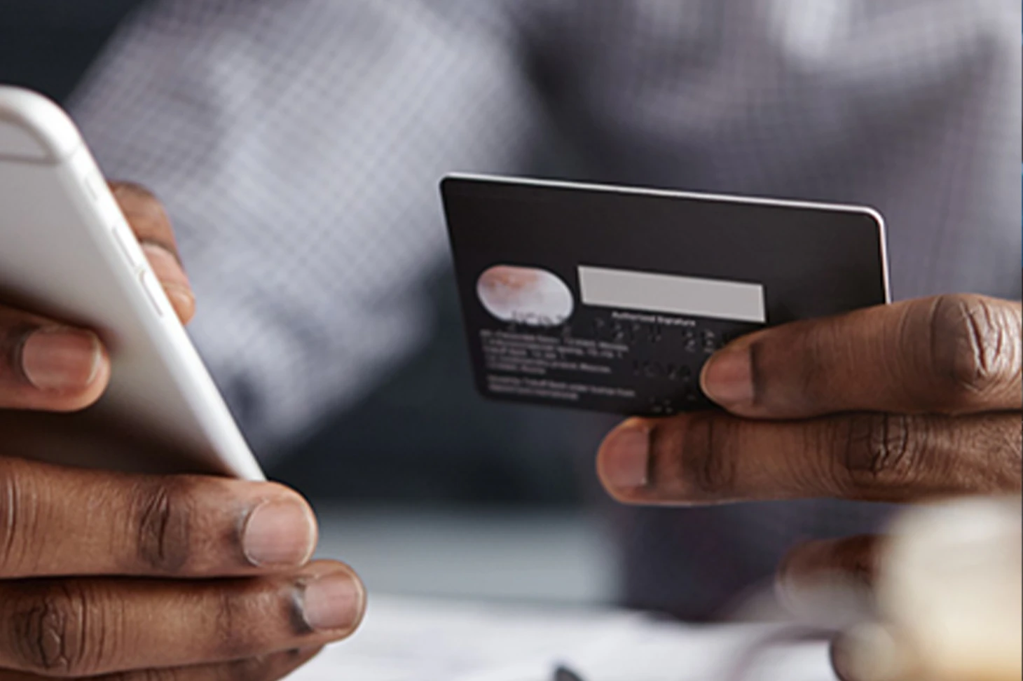 Customer paying online with a phone and card, the kind of checkout I build into e-commerce websites
